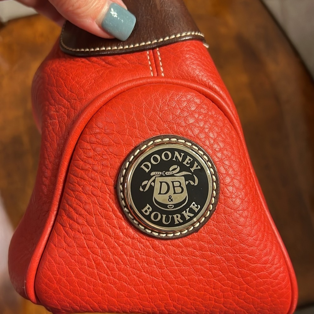 Dooney & Bourke vibrant red leather handbag with dark brown leather handle